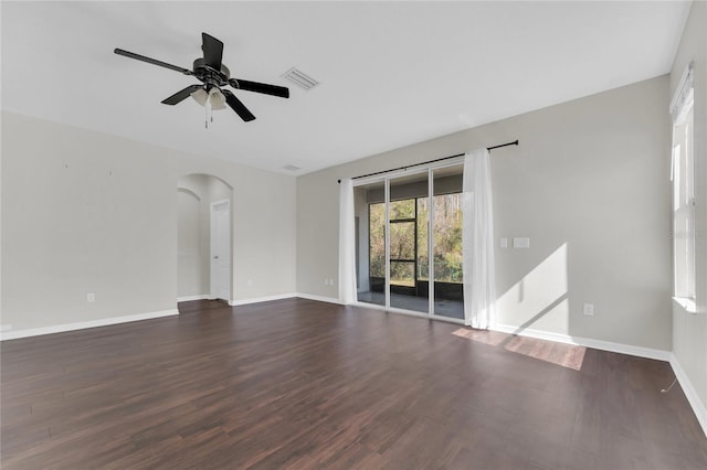 spare room with dark hardwood / wood-style floors and ceiling fan