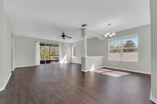 unfurnished living room with ornate columns, dark hardwood / wood-style floors, and ceiling fan with notable chandelier