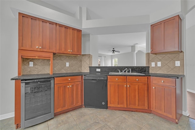 kitchen featuring sink, ceiling fan, dark stone countertops, black dishwasher, and beverage cooler