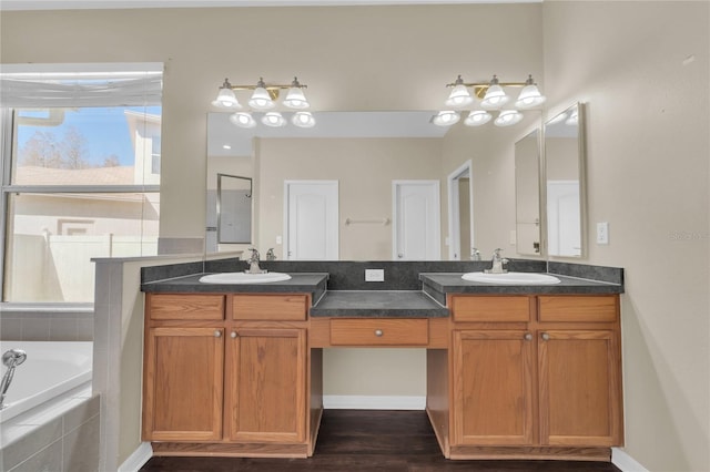 bathroom with vanity, hardwood / wood-style flooring, and tiled bath