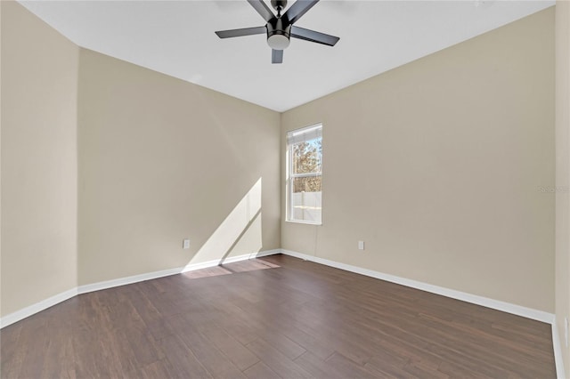 unfurnished room featuring dark wood-type flooring and ceiling fan