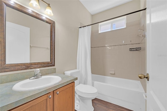 full bathroom with hardwood / wood-style flooring, vanity, toilet, and shower / tub combo