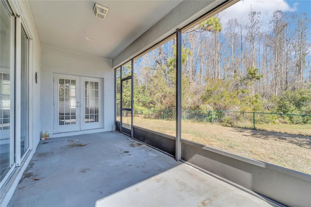 unfurnished sunroom with french doors