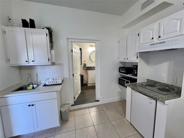 kitchen featuring electric cooktop, tasteful backsplash, sink, white cabinets, and light tile patterned floors