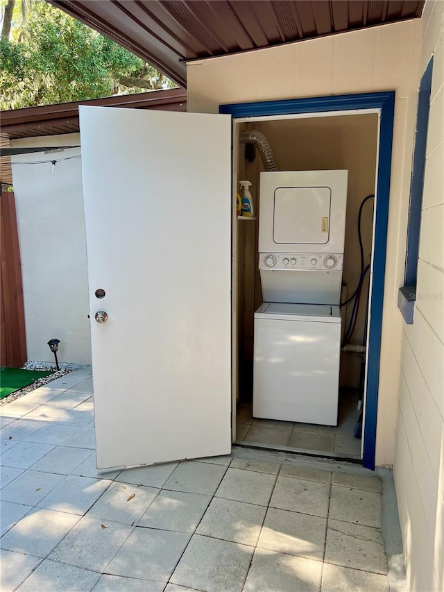 washroom with stacked washer and dryer