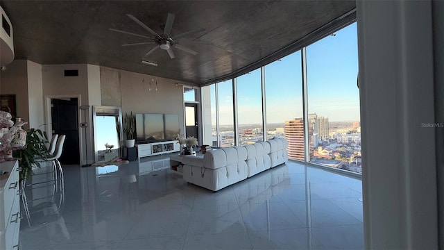 living room featuring expansive windows and ceiling fan