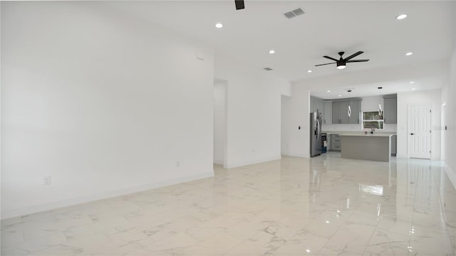 unfurnished living room featuring ceiling fan