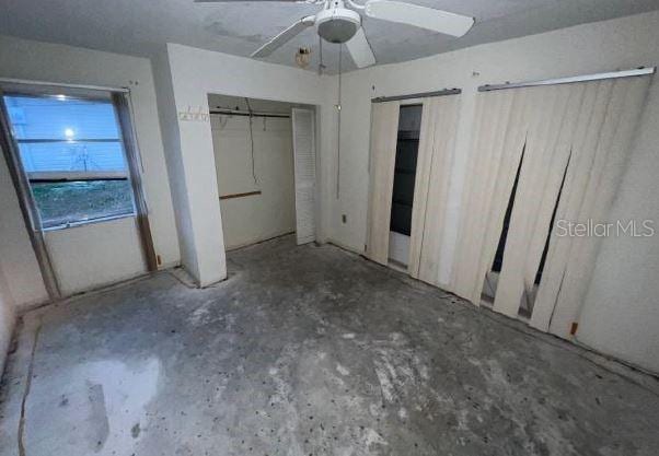 unfurnished bedroom featuring ceiling fan and concrete floors