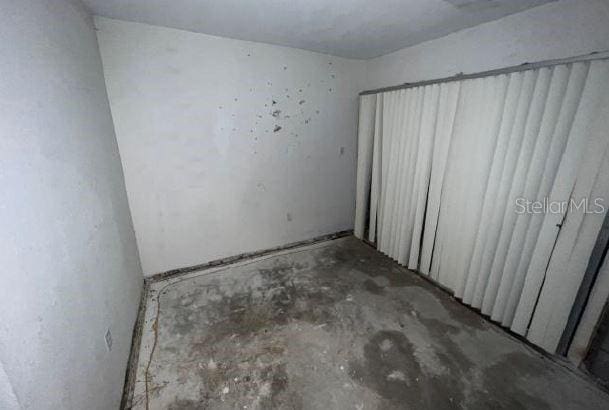 unfurnished room with concrete floors