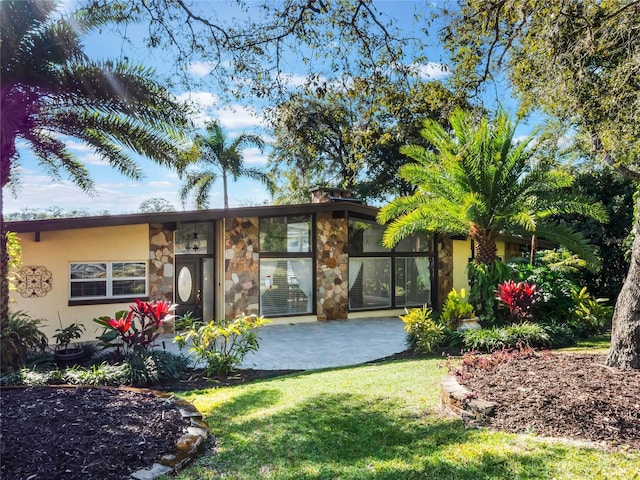 exterior space with a patio and a front yard