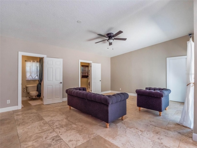 living room featuring a textured ceiling and ceiling fan