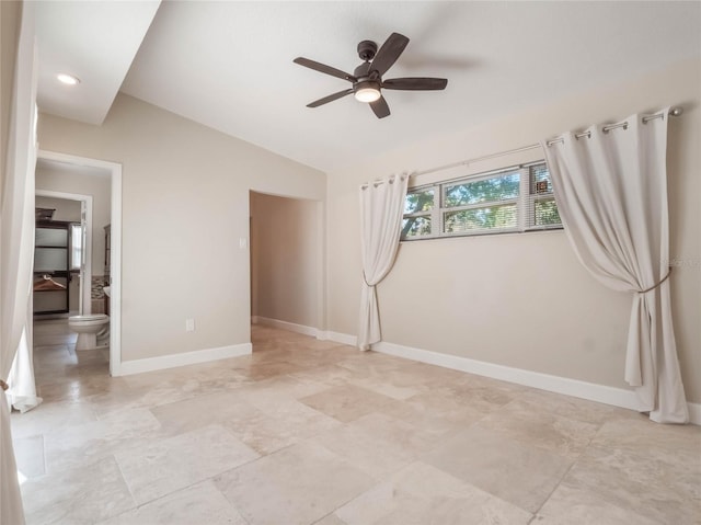 spare room featuring vaulted ceiling and ceiling fan