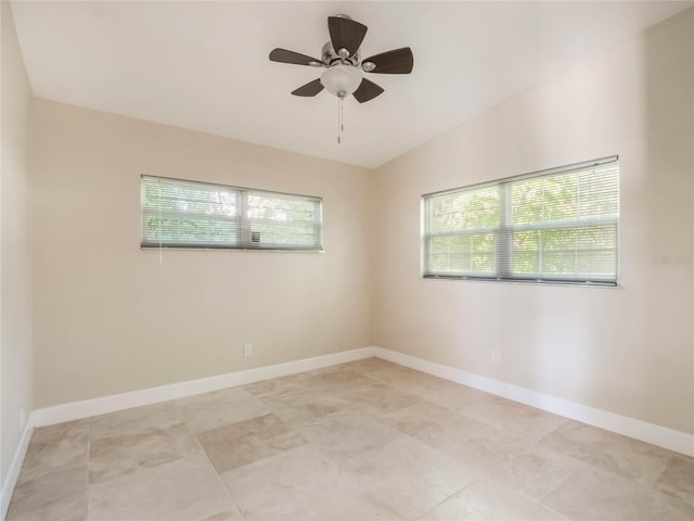 spare room featuring vaulted ceiling and ceiling fan