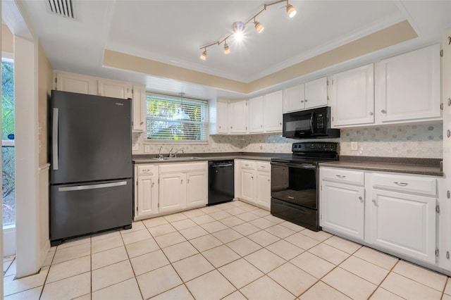 kitchen featuring white cabinetry, a tray ceiling, sink, and black appliances