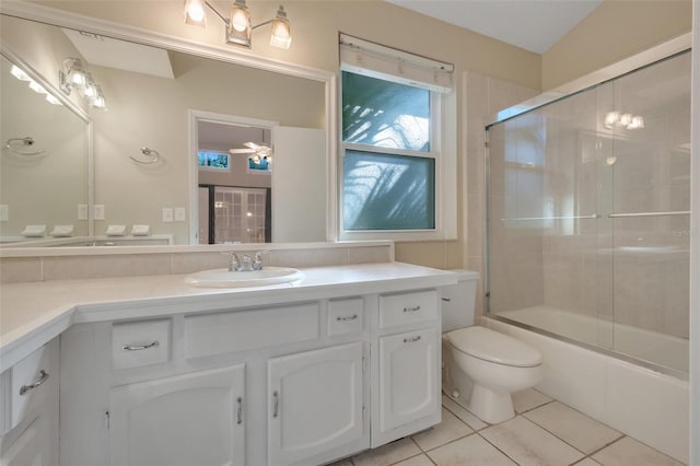 full bathroom with tile patterned flooring, bath / shower combo with glass door, vanity, and toilet