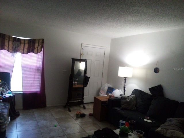 tiled living room with a textured ceiling