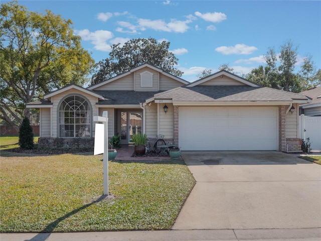 ranch-style home with a garage and a front yard