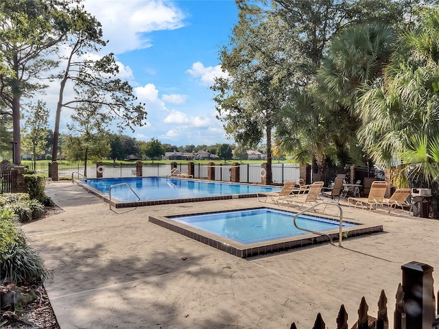 view of swimming pool with a patio and a community hot tub