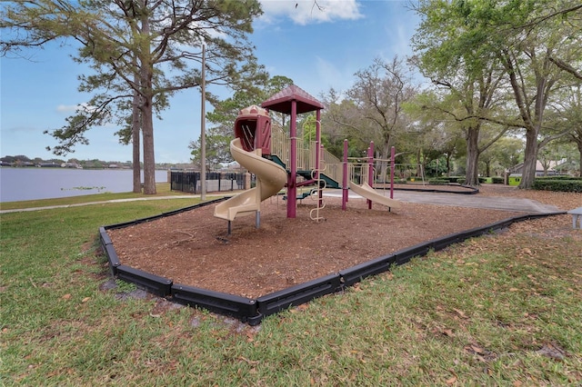 view of play area with a yard and a water view