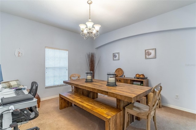 dining area featuring light carpet and a notable chandelier