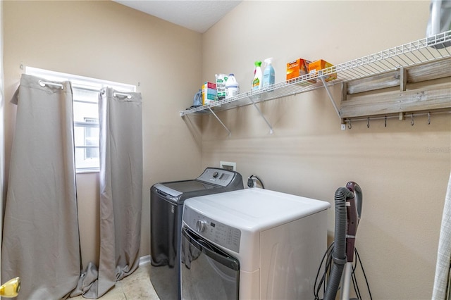 washroom featuring independent washer and dryer and light tile patterned floors