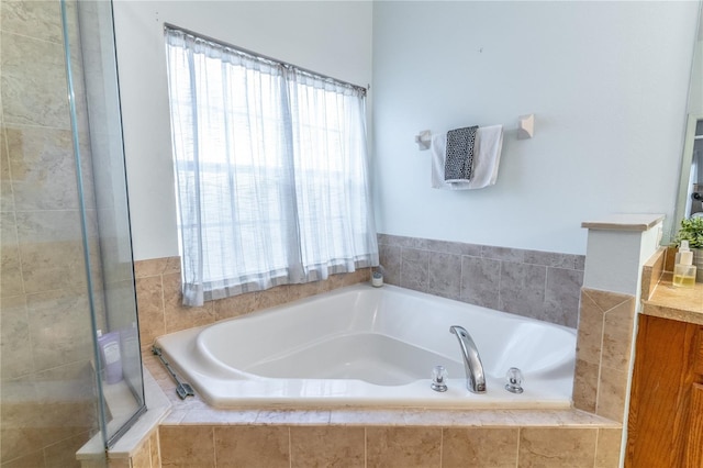 bathroom with vanity and independent shower and bath