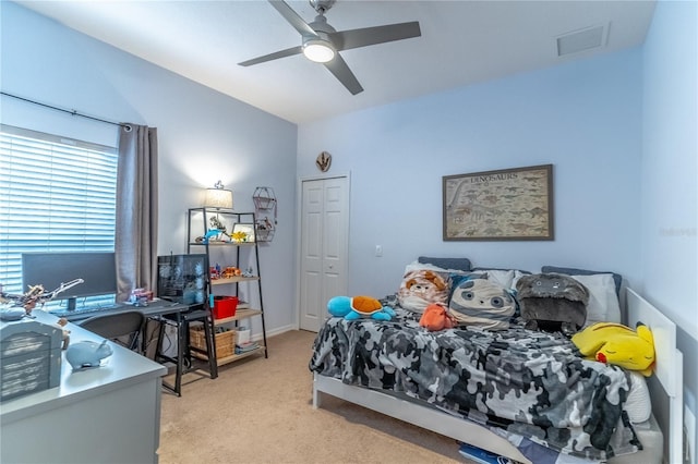 carpeted bedroom with ceiling fan and vaulted ceiling