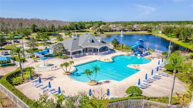 view of pool with a patio, a water view, a playground, and a water slide