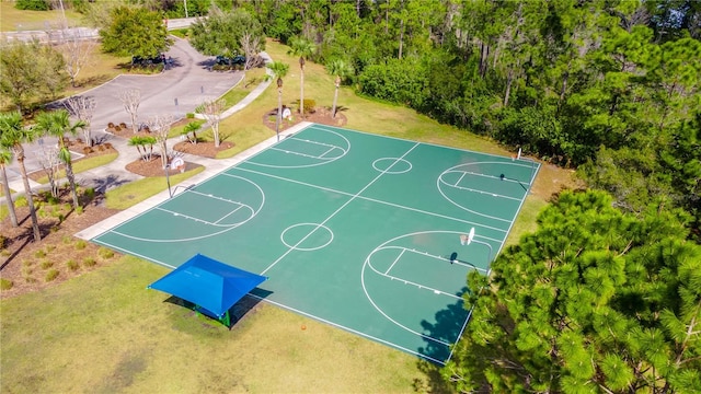 view of basketball court with a yard