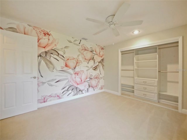 unfurnished bedroom featuring carpet flooring, ceiling fan, and a closet