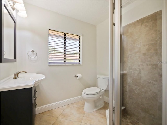 bathroom featuring vanity, tile patterned floors, toilet, and walk in shower