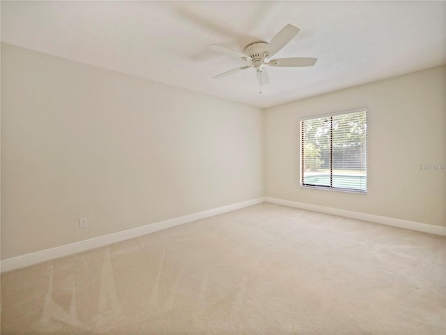 unfurnished room featuring ceiling fan and light carpet