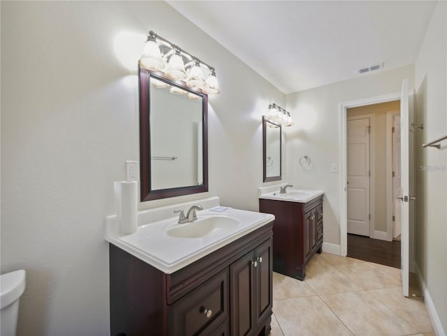 bathroom featuring vanity, tile patterned floors, and toilet