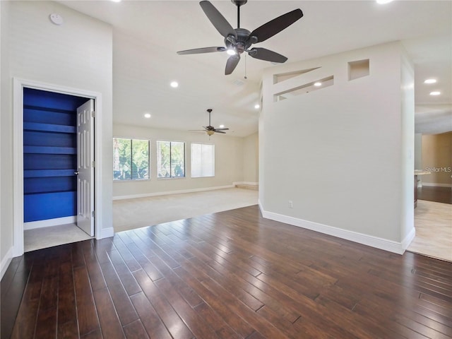 unfurnished living room featuring lofted ceiling and wood-type flooring