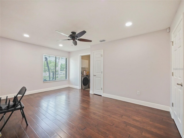 unfurnished office featuring washer / clothes dryer, dark hardwood / wood-style floors, and ceiling fan