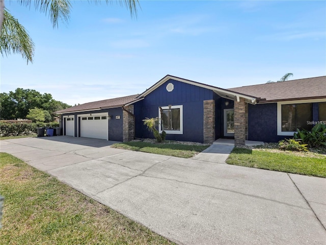 ranch-style house with a garage and a front yard