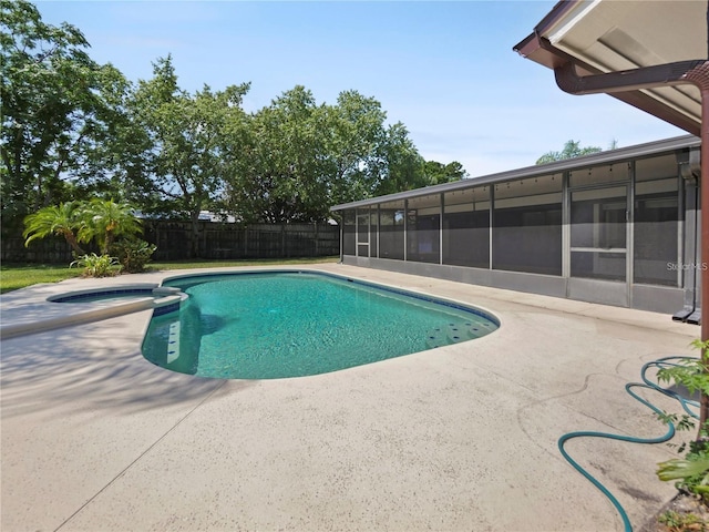 view of swimming pool featuring an in ground hot tub, a patio area, and a sunroom