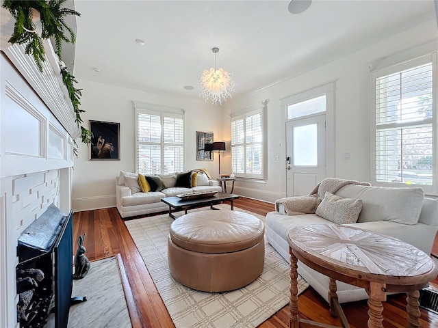 living room featuring an inviting chandelier and light hardwood / wood-style flooring