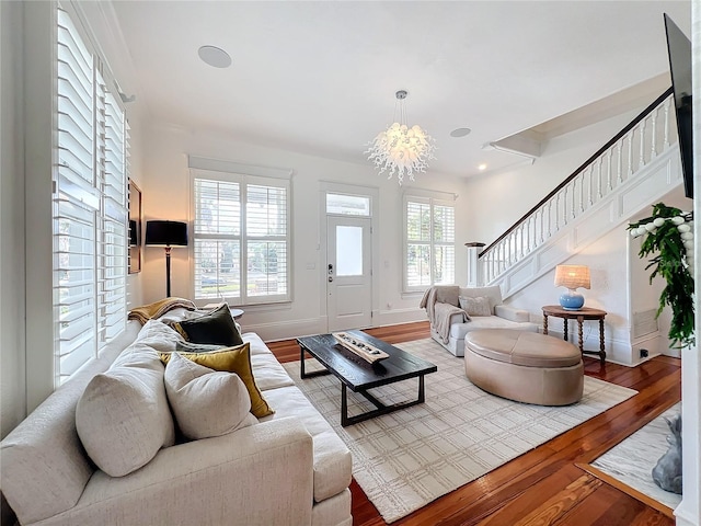 living room with hardwood / wood-style flooring and a chandelier