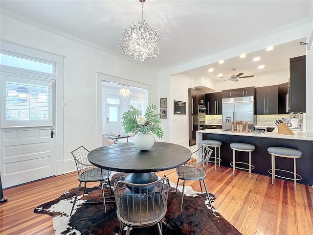 dining area with crown molding, a healthy amount of sunlight, and hardwood / wood-style floors