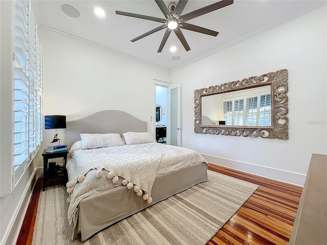 bedroom featuring hardwood / wood-style flooring, crown molding, and ceiling fan