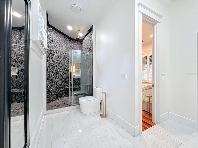 bathroom with walk in shower and toilet