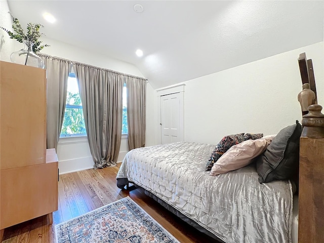 bedroom featuring lofted ceiling and wood-type flooring