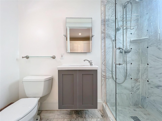 bathroom with toilet, vanity, and a shower with shower door