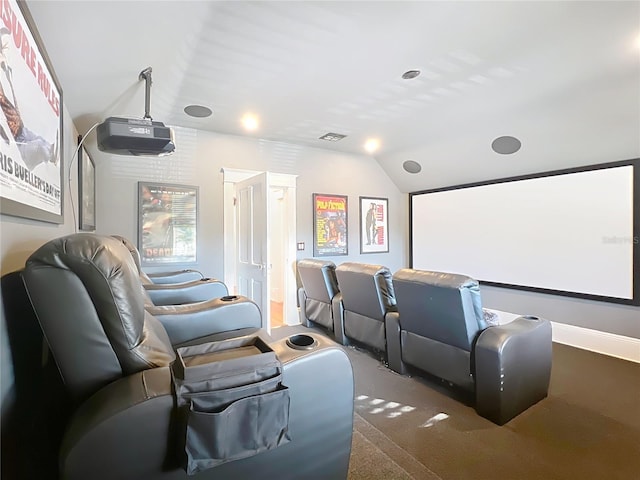 carpeted home theater featuring vaulted ceiling