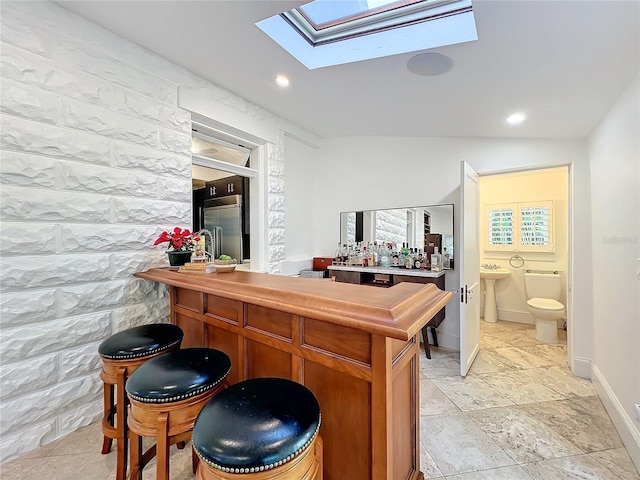 bar with sink and built in fridge