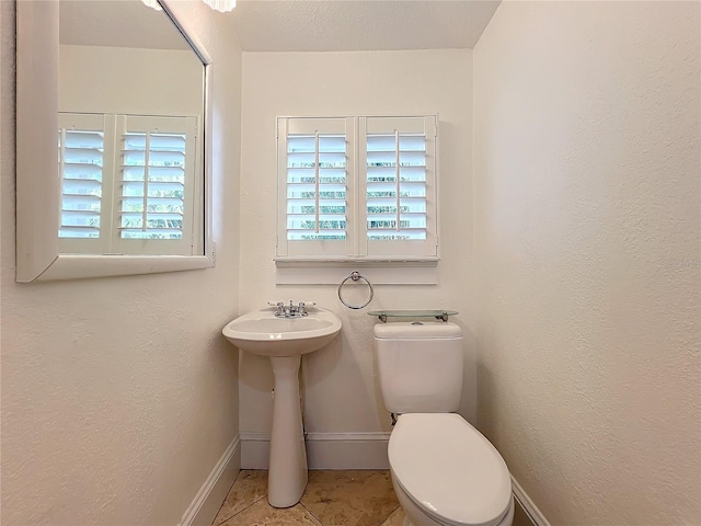 bathroom with tile patterned floors and toilet