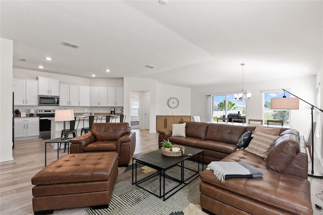 living room featuring light hardwood / wood-style flooring and a chandelier