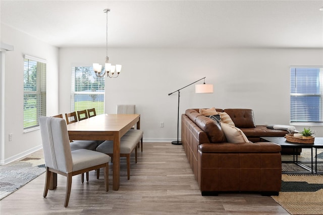 dining room with a chandelier and light wood-type flooring