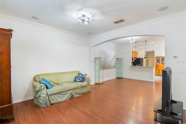 sitting room featuring crown molding and light wood-type flooring